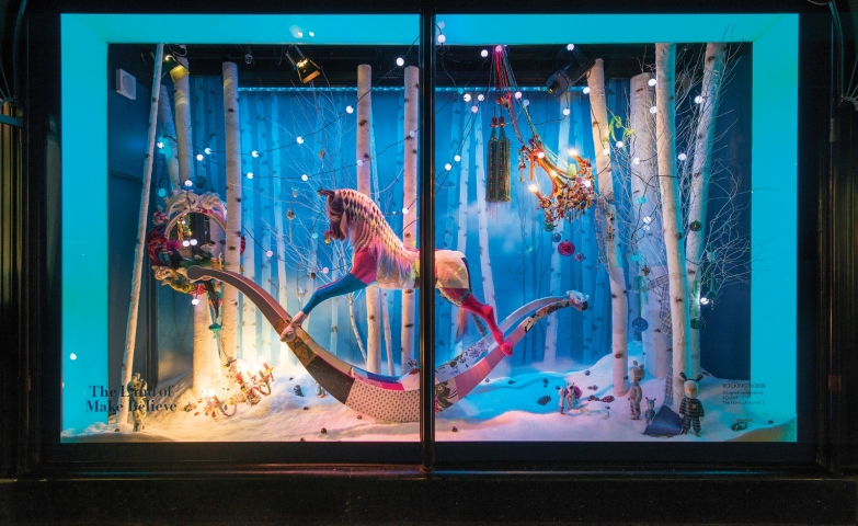 For this window display, we have a carousel horse surrounded by lights and placed on a woods background.