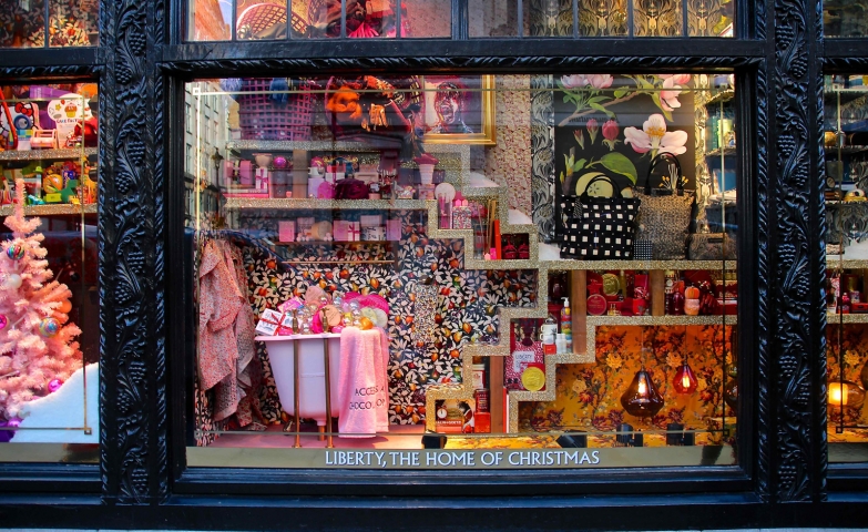 At liberty home of Christmas, the window display is full of patterns, prints most in pink but also in orange and black.