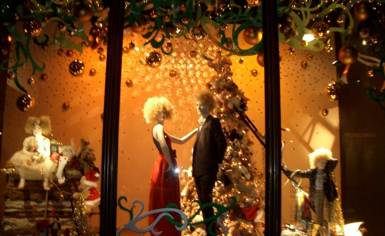 A magic Christmas night near the white fir and under the green tinsels, for two elegant dressed mannequins from this window display.