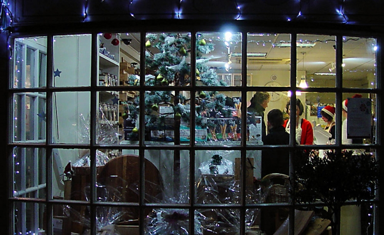 Only a few packed cookies and blue lights inside the Christmas window display.