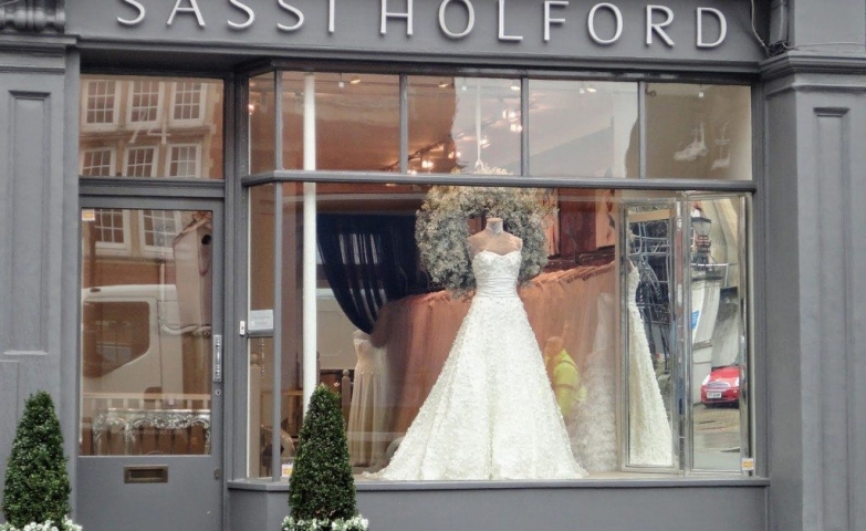 Sassi Holford decorated the window display with a simple and beautiful wedding dress and a Christmas wreath.