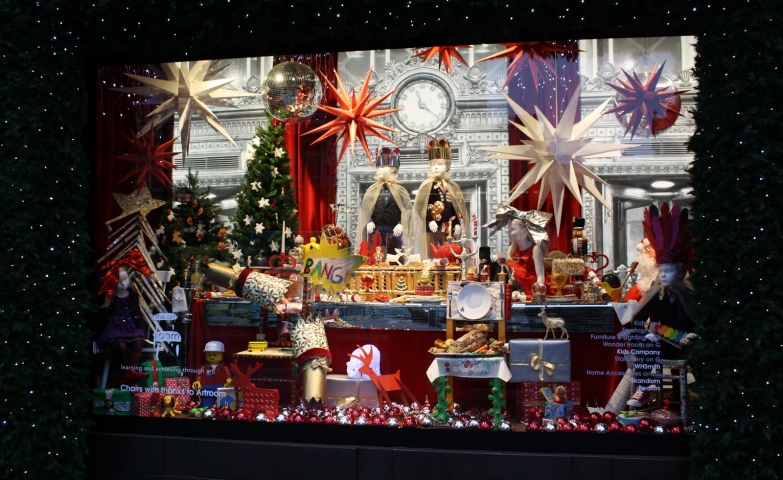A table with goodies, presents and proper decoration in this Christmas window display.