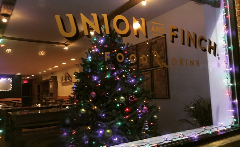 Union and Finch have a rich decorated fir placed in the Christmas window display, with lights that are also added to the outside of the window.