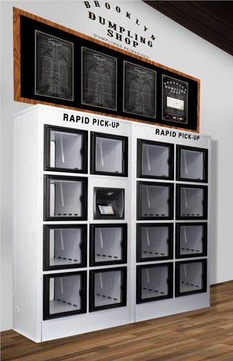 A stack of glass lockers with a blackboard on top that has food items printed on it